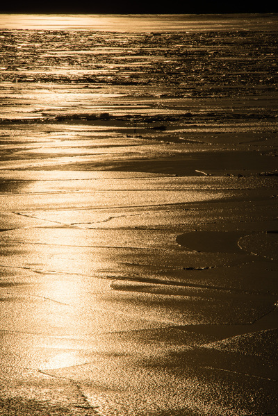 A golden river with frozen icy waves.